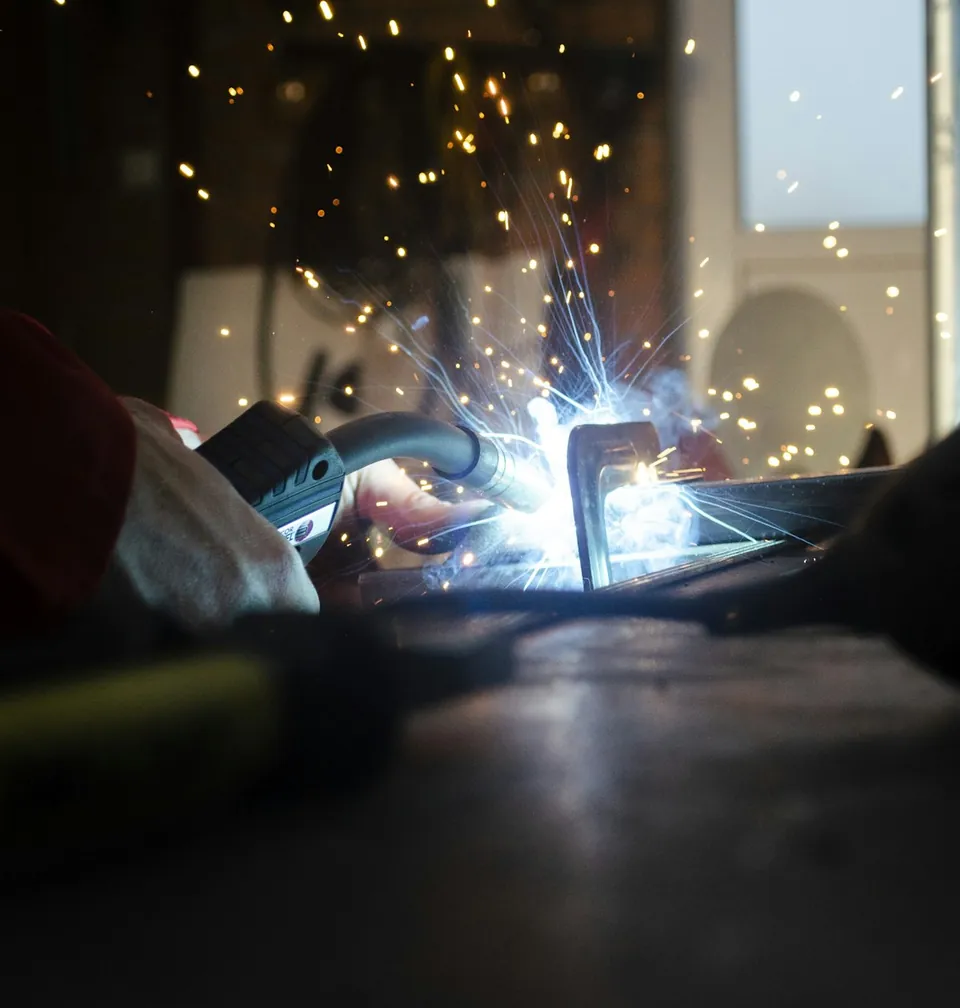 Soldador Recoleta Antorcha de soldadura sobre una pieza en una mesa de taller